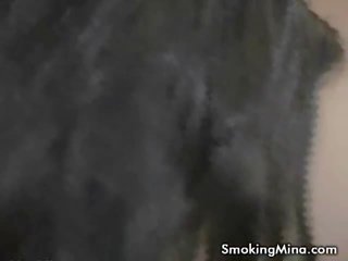 Charming black haired honey smoking in bathtub