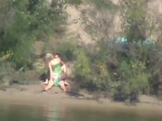 Shy and concupiscent young woman rides cock on the river