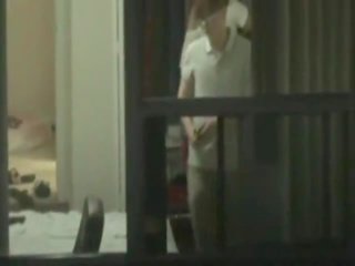 Cute asian chick caught changing by a window peeper
